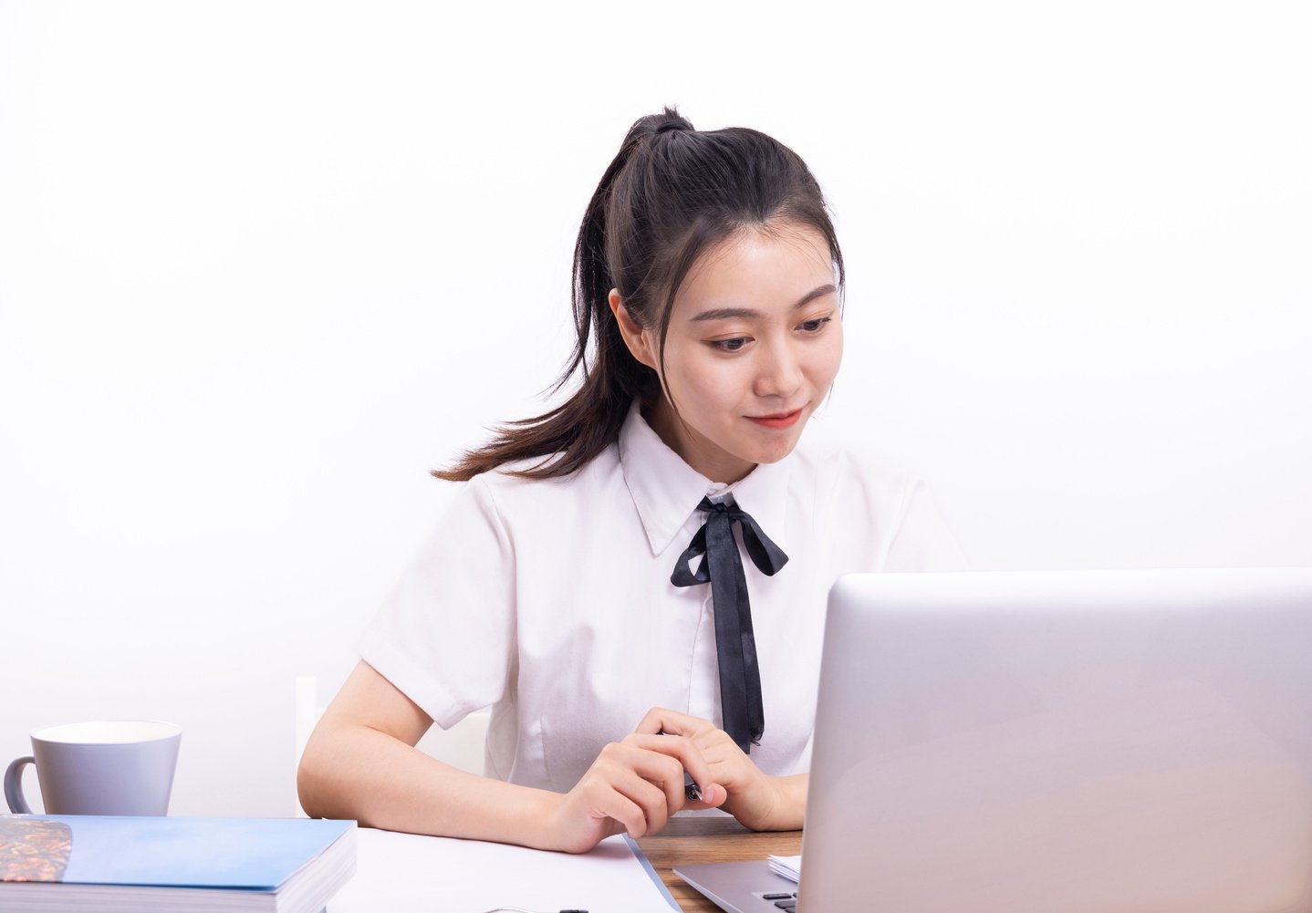 Asian female student taking an online class on white background